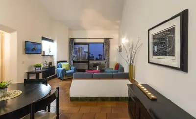 a living room with a couch and a table at Apartamentos Azul Mar in Albufeira