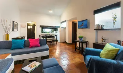 a living room with two blue couches and a table at Apartamentos Azul Mar in Albufeira