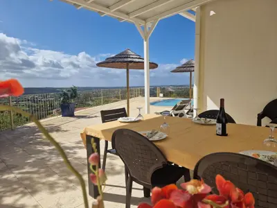 a dining table with a view of the ocean at Quinta Sabaudia in Gateiras