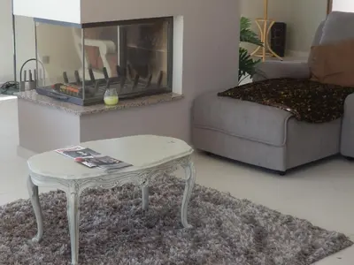 a living room with a coffee table and a fireplace at Quinta Sabaudia in Gateiras