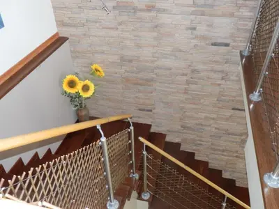 a staircase with a brick wall and a vase of sunflowers at Quinta Sabaudia in Gateiras
