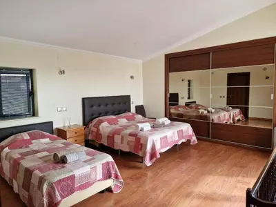 a bedroom with two beds and a large mirror at Quinta Sabaudia in Gateiras