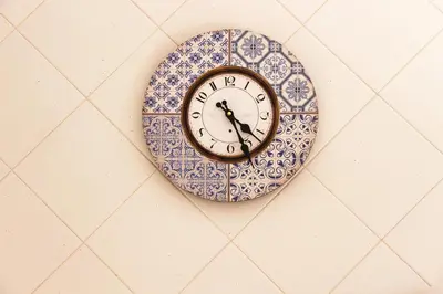 a clock is hanging on a wall at Alameda Garden in Faro