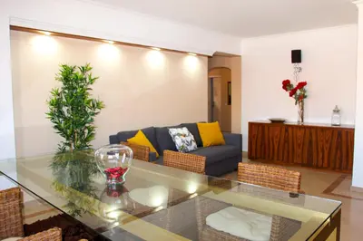 a living room with a glass table and a couch at Alameda Garden in Faro