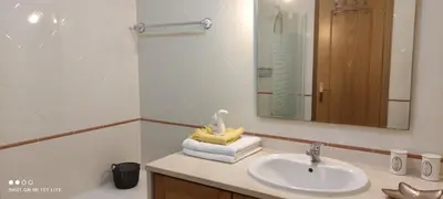 a bathroom with a white toilet and a sink at Appartement Villamoura in Vilamoura