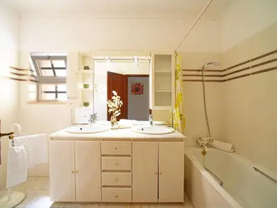 a bathroom with two sinks and a tub and a mirror at Holiday Home Da Bela Vista by Interhome in Paderne