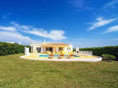 a house with a pool and chairs in the yard at Holiday Home Da Bela Vista by Interhome in Paderne