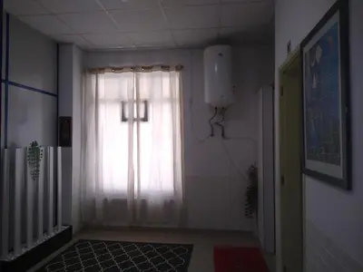 a hallway with a window with a window curtain at Melaya Budget Hostel in Faro