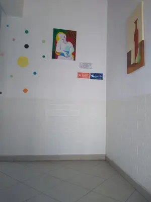 a white room with some pictures on the wall at Melaya Budget Hostel in Faro