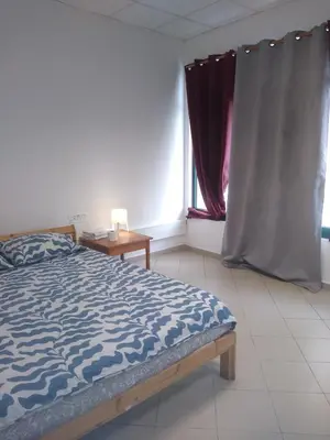 a bedroom with a bed and a window at Melaya Budget Hostel in Faro