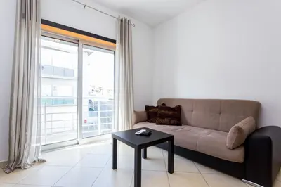 a living room with a couch and a table at Ouranascente in Albufeira