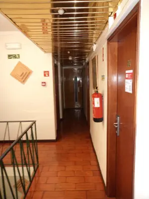 a hallway with a fire extinguisher in a building at VilaBranca in Albufeira
