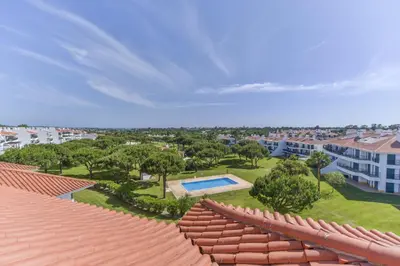 an overhead view of a roof of a house with a swimming pool at Apartamento Vila Sol com terraço e jacuzzi privad in Quarteira