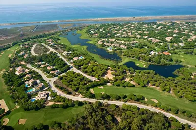 an aerial view of a golf course with a river at THE LAKERS Boutique Apartment in Quinta do Lago