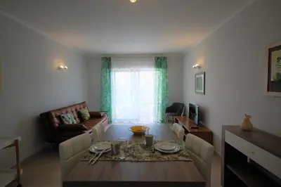 a living room with a table and a couch at Apartamento Velamar - 250 m from the Beach by Bedzy in Albufeira