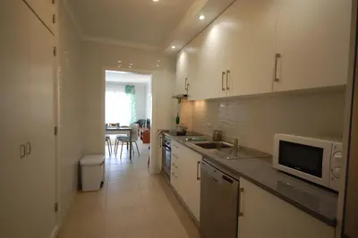 a kitchen with a sink and a microwave at Apartamento Velamar - 250 m from the Beach by Bedzy in Albufeira