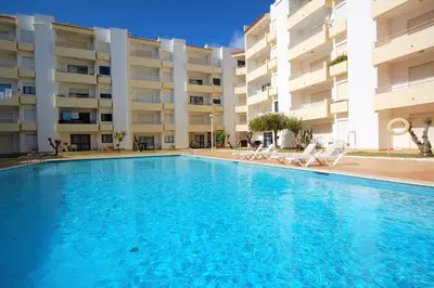 a large swimming pool in front of a building at Apartamento Velamar - 250 m from the Beach by Bedzy in Albufeira