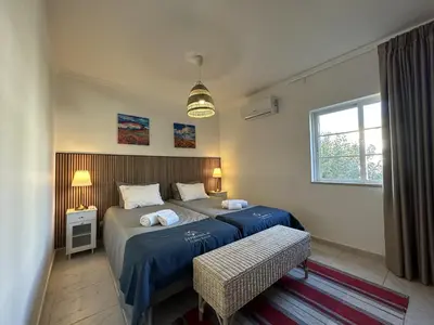a bedroom with two beds and a window at Citymar by FHR T2 com piscina in Vilamoura