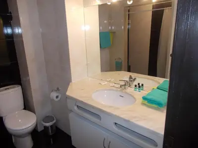 a bathroom with a sink and a toilet and a mirror at Bellavista Studio in Albufeira