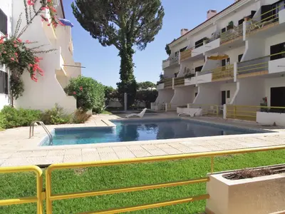 a swimming pool in front of a building at Sol Nascente- Piscina, Wifi, Familiar in Vilamoura