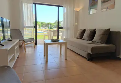 a living room with a couch and a table at Sol Nascente- Piscina, Wifi, Familiar in Vilamoura