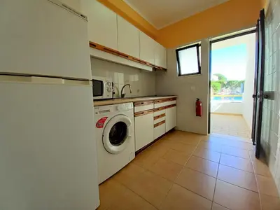 a kitchen with a washer and dryer in it at Sol Nascente- Piscina, Wifi, Familiar in Vilamoura