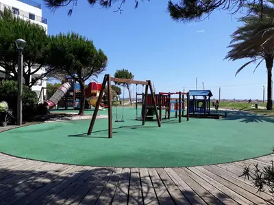 a park with a playground with a slide at SATÉLITE AC&Garagem in Quarteira