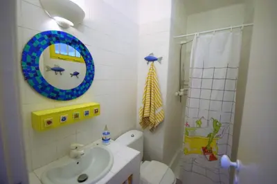 a bathroom with a sink and a toilet and a mirror at V2 Aldeia Do Golf- Piscina, Familiar, Aconchegante in Vilamoura