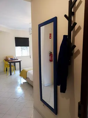 a kitchen with white cabinets and a sink and a microwave at Kiss - Apartamentos in Albufeira