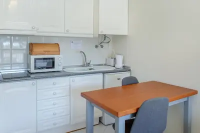 a living room with a blue couch and a chair at Kiss - Apartamentos in Albufeira