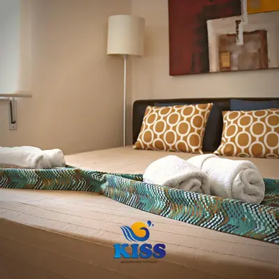 a hotel room with two beds with towels on them at Kiss - Apartamentos in Albufeira
