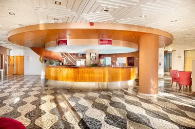 a lobby with a reception desk in a building at Muthu Oura Praia Hotel in Albufeira