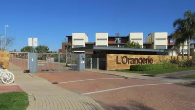 a gate in a parking lot with a library at L Orangerie CA by Intiholidays in Vilamoura