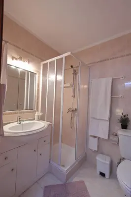 a bathroom with a shower and a sink and a toilet at Casa das Andorinhas in Faro