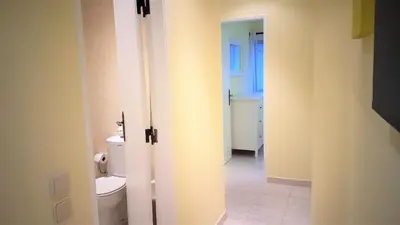 an open door to a bathroom with a toilet at Mouramar- Garagem, Piscina & Wifi in Vilamoura