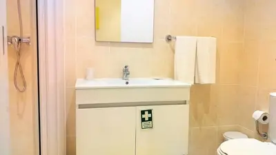 a bathroom with a sink and a toilet at Mouramar- Garagem, Piscina & Wifi in Vilamoura