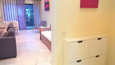 a living room with a couch and a table at Mouramar- Garagem, Piscina & Wifi in Vilamoura