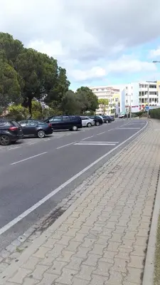 a street with cars parked on the side of the road at Tenis Golfmar 409A - pool view in Vilamoura