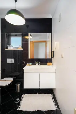 a bathroom with a white sink and a mirror at Loulé Charming in Loulé