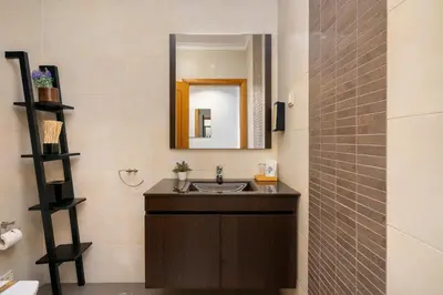 a bathroom with a sink and a mirror at Loulé Charming in Loulé