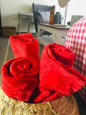 two red towels sitting on top of a basket at Loulé Charming in Loulé