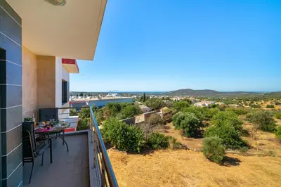 a balcony with a table and chairs and a view at Loulé Charming in Loulé