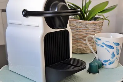 a coffee maker sitting on a table next to a cup at Aquamarine - Gemstone Getaway in Vale do Lobo