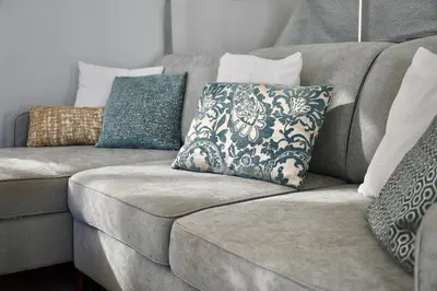 a couch with pillows on top of it at Aquamarine - Gemstone Getaway in Vale do Lobo