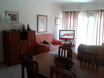 a living room with a couch and a table at Apartamento Praia da Falésia in Albufeira
