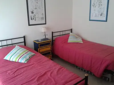 two beds sitting next to each other in a bedroom at Apartamento Praia da Falésia in Albufeira