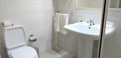 a white bathroom with a toilet and a sink at Avenida Mar- Vista Mar, Wifi, 150mt Praia in Quarteira