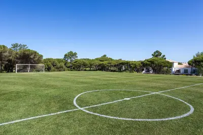 an empty soccer field with a soccer ball at Pine Cliffs Gardens in Albufeira