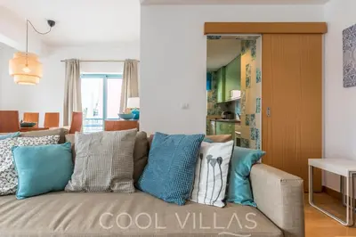 a living room with a couch with pillows on it at Marina Water View - 6 people, bars & restaurants in Albufeira