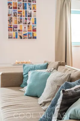 a couch with pillows on it in a living room at Marina Water View - 6 people, bars & restaurants in Albufeira